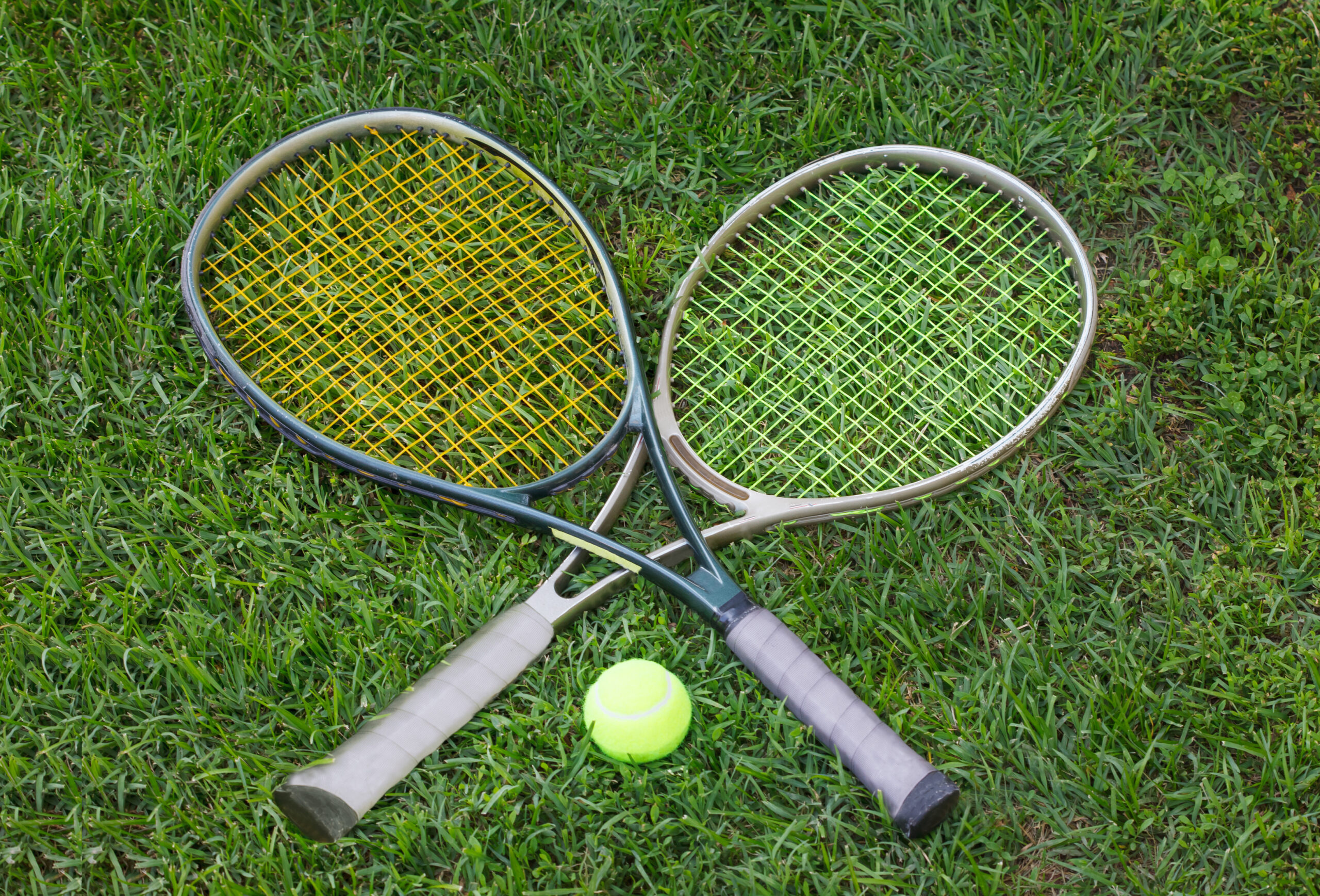 Tennis rackets and tennis ball on grass, Wimbledon tennis.